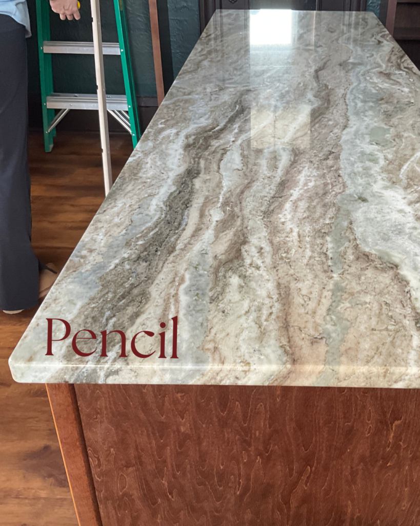 Pencil countertop edge profile on quartzite kitchen island with dramatic gray veining